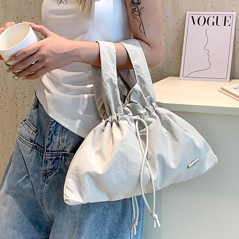 

New women s retro bundle literary and pastoral handbag solid color drawstring commuter bag