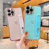 Applicable to iphone17pro mobile phone case Apple hollow love + bracket wristband new 15 Apple 16promax