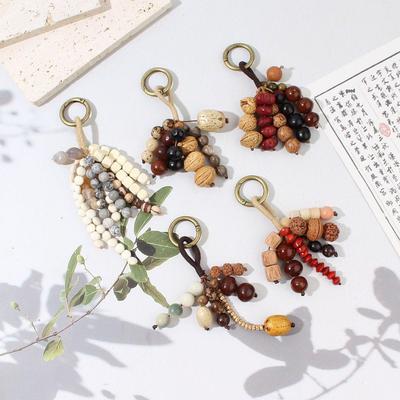 Hand-Woven Natural Seed & Fruit Shell Keychain: Retro Wind Chime Style Ornament for Bags or Cars.