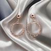 Triple-ring and rhinestone earrings for a glamorous rose gold look