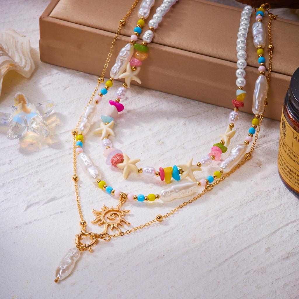 Bohemian Handgefertigter Seestern Sonne Anhänger Halskette für Damen Sommer Muschel Imitation Perle Reiskorn Perlen Choker Strandurlaub Schmuck