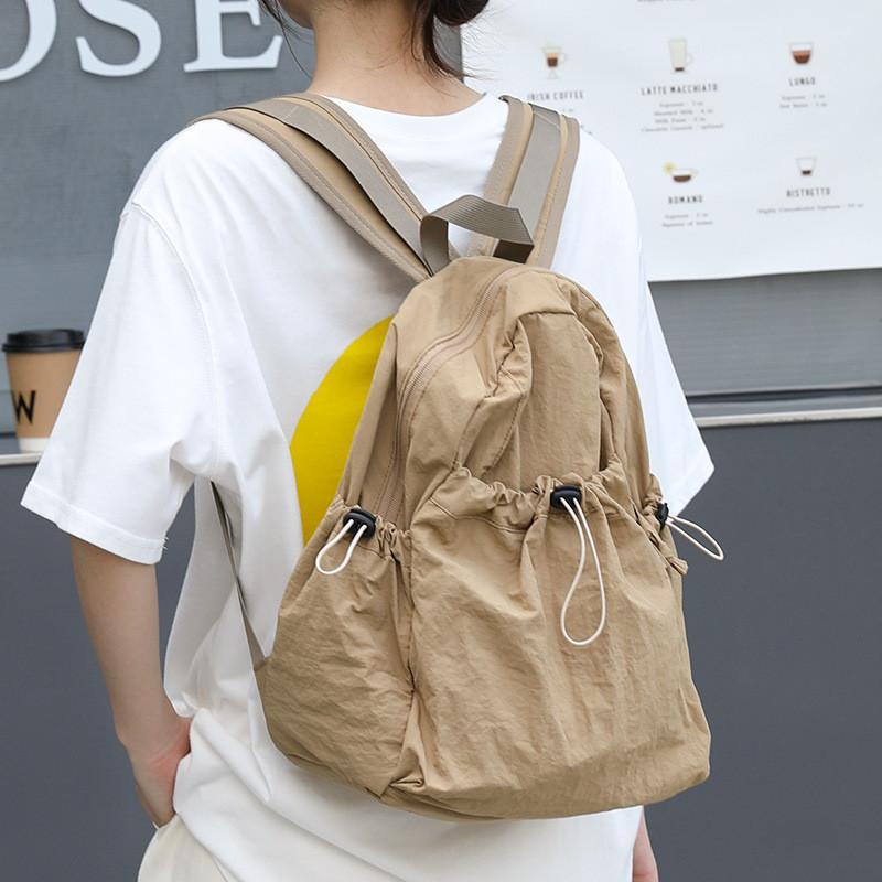 IELGY Korean version of casual literary canvas schoolbag, pleated nylon drawstring backpack, fashionable Oxford cloth backpack.