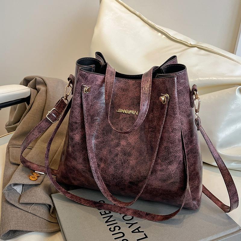 Beliebte Taschen für Frauen Große Kapazität Neue Retro-Mode Breitbandige Einzel-Schulter Crossbody-Tasche Hand-Eimer-Tasche