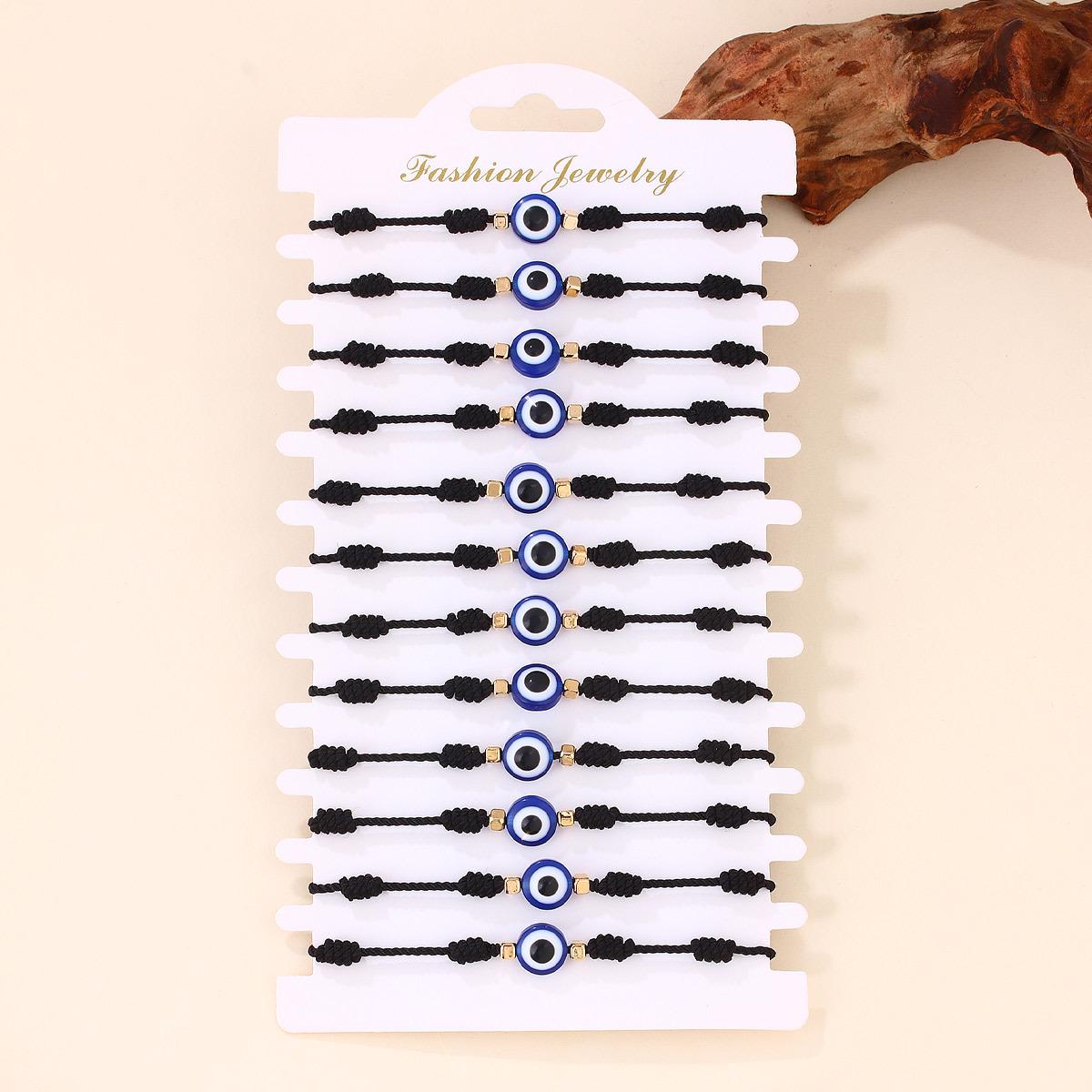 

Набір браслетів з червоної нитки з синім намистом «Око диявола» - Ручна робота, плетіння