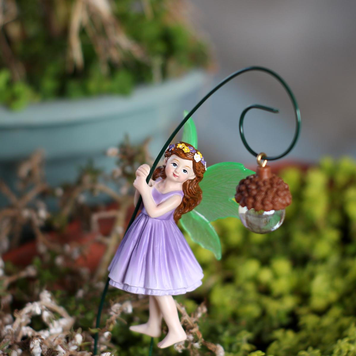 2 purple dresses, fairy carrying pine cones, fluorescent winged girl, bonsai statue, fairy tale scene decoration, family gift