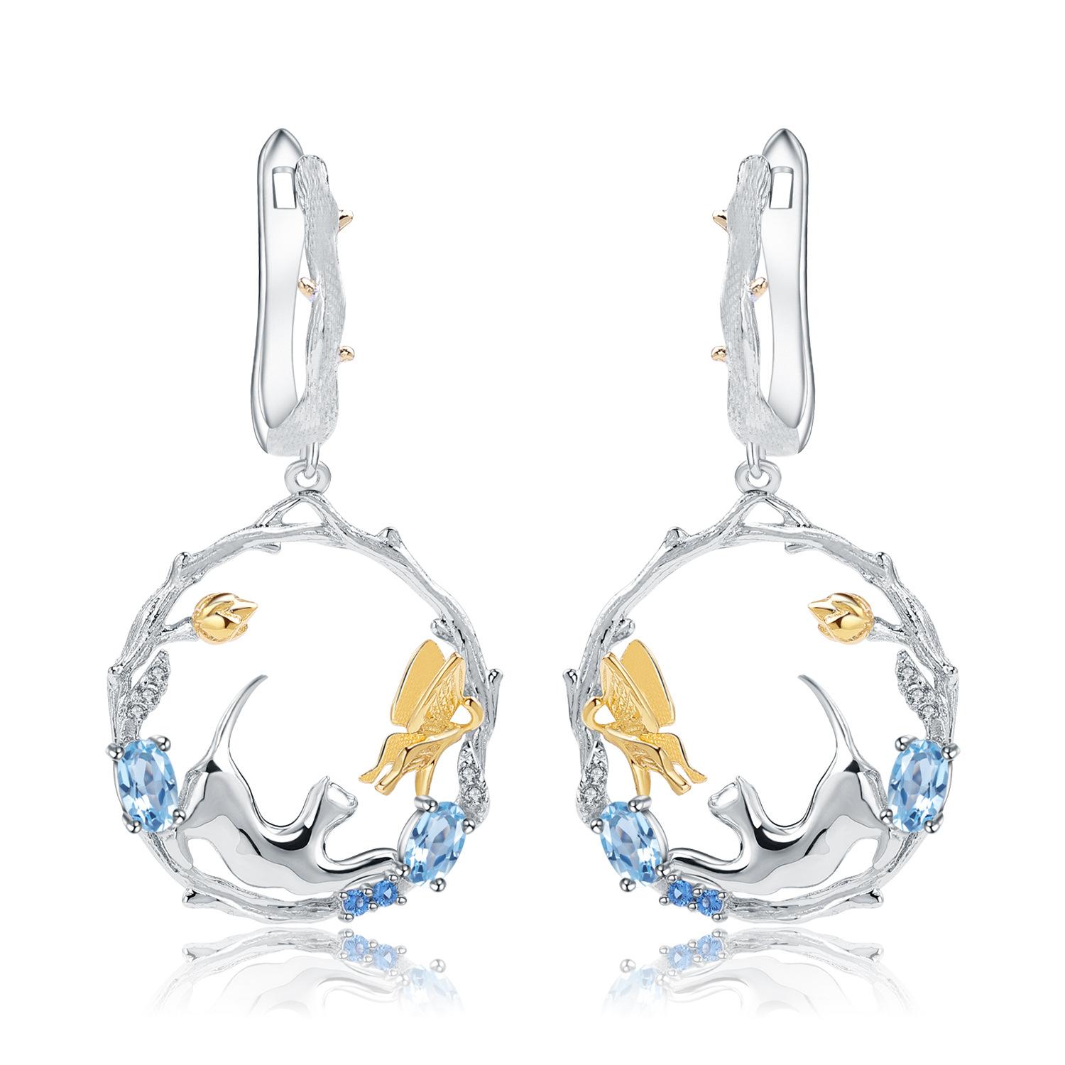 

Оригинальные дизайнерские серьги в национальном стиле с драгоценными камнями. Серьги-гвоздики с топазом из серебра 925 пробы в естественном стиле с животным дизайном.