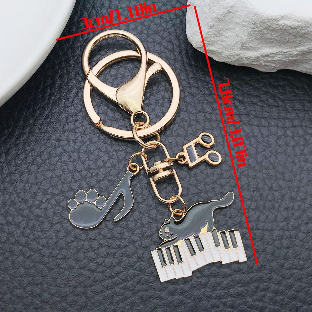 Well-Behaved Black Cat Zinc Alloy Keychain: Cute Drip Oil Cartoon Pendant for Backpacks