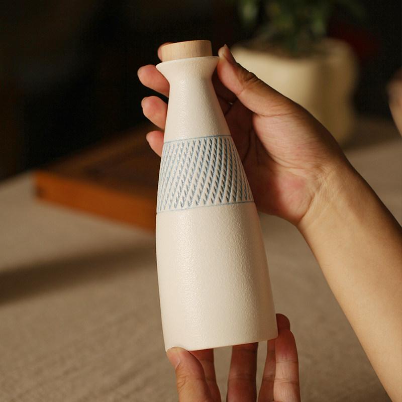 

Ceramic Sake Bottle White Textured Liquor Decanter with Wooden Stopper Blue Pattern Band For Home Bar Sake Serving Table Decor