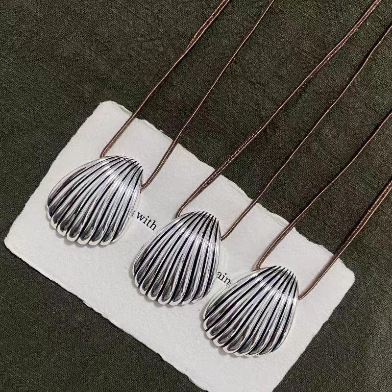 Elegant Silver Seashell Pendant Necklace with Brown Leather Cord
