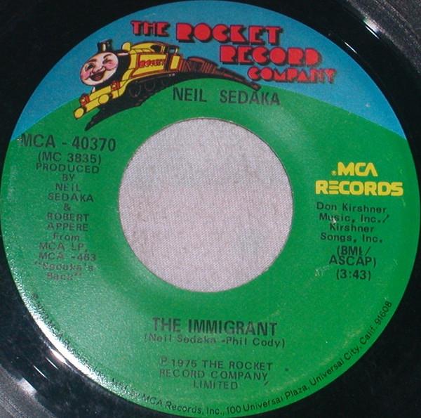 

7inch Record NEIL SEDAKA - The Immigrant MCA40370 The Rocket Reco 1974 US Pop Used
