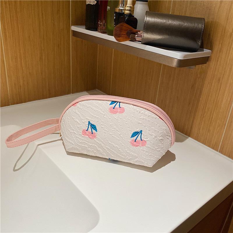 2026New half-moon-shaped floral hand-held cosmetic bag, portable makeup organizer, cute and unique, perfect as a small pouch or pencil case