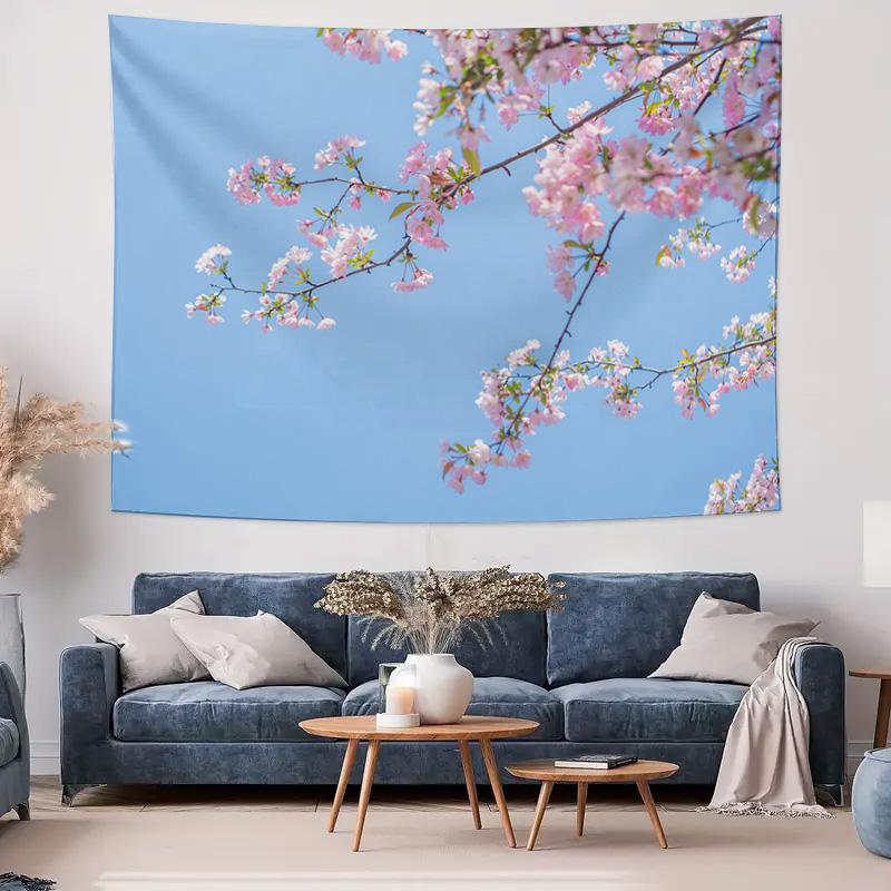Pink cherry blossoms bloom on an indoor wall decoration tapestry against a blue sky background