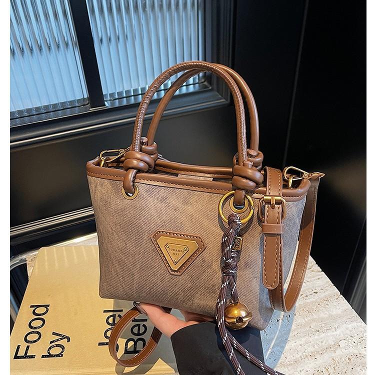 Spring new simple retro hand bucket bag women's shoulder bag high-end texture niche messenger bag