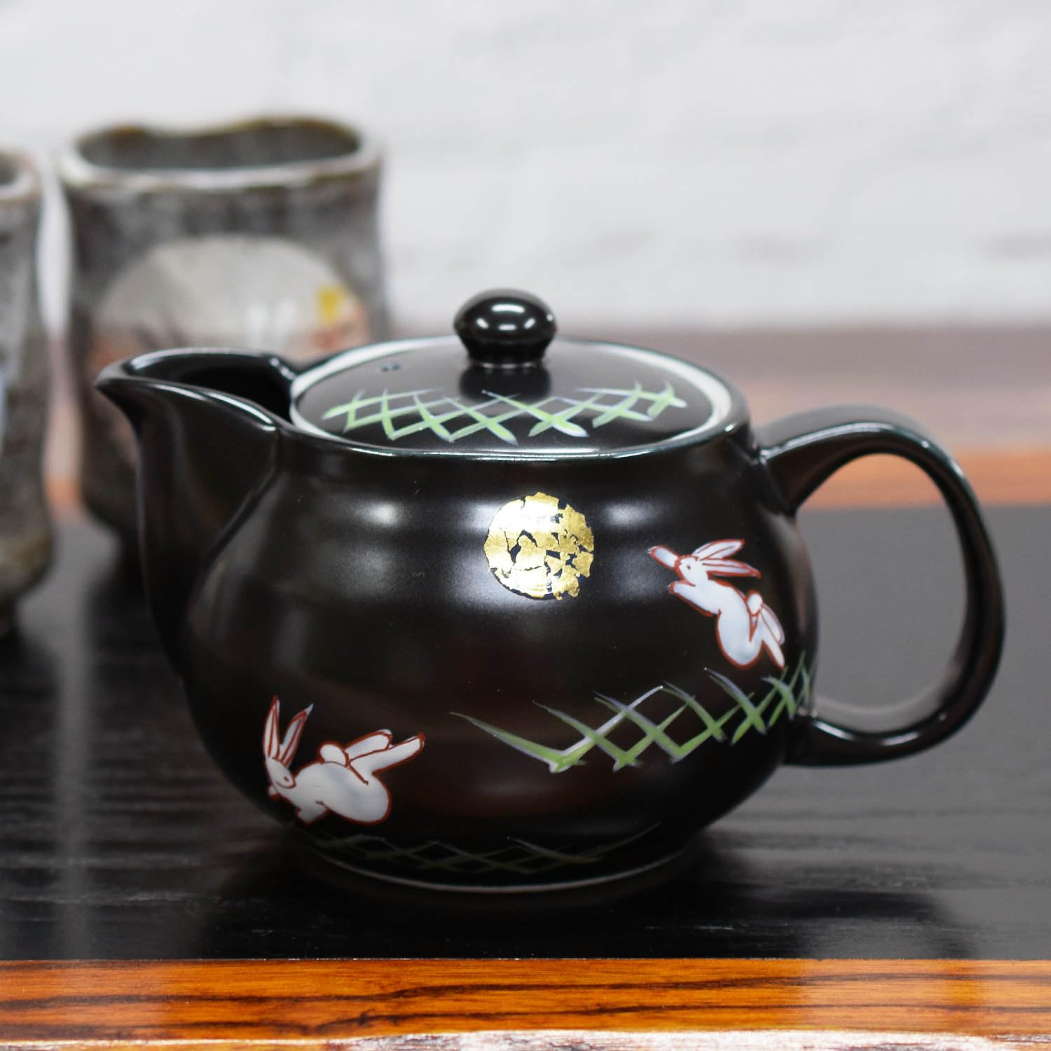 

Stylish Kutani ware teapot with a moon rabbit design, made in Japan by Waza no Kura, with tea strainer included