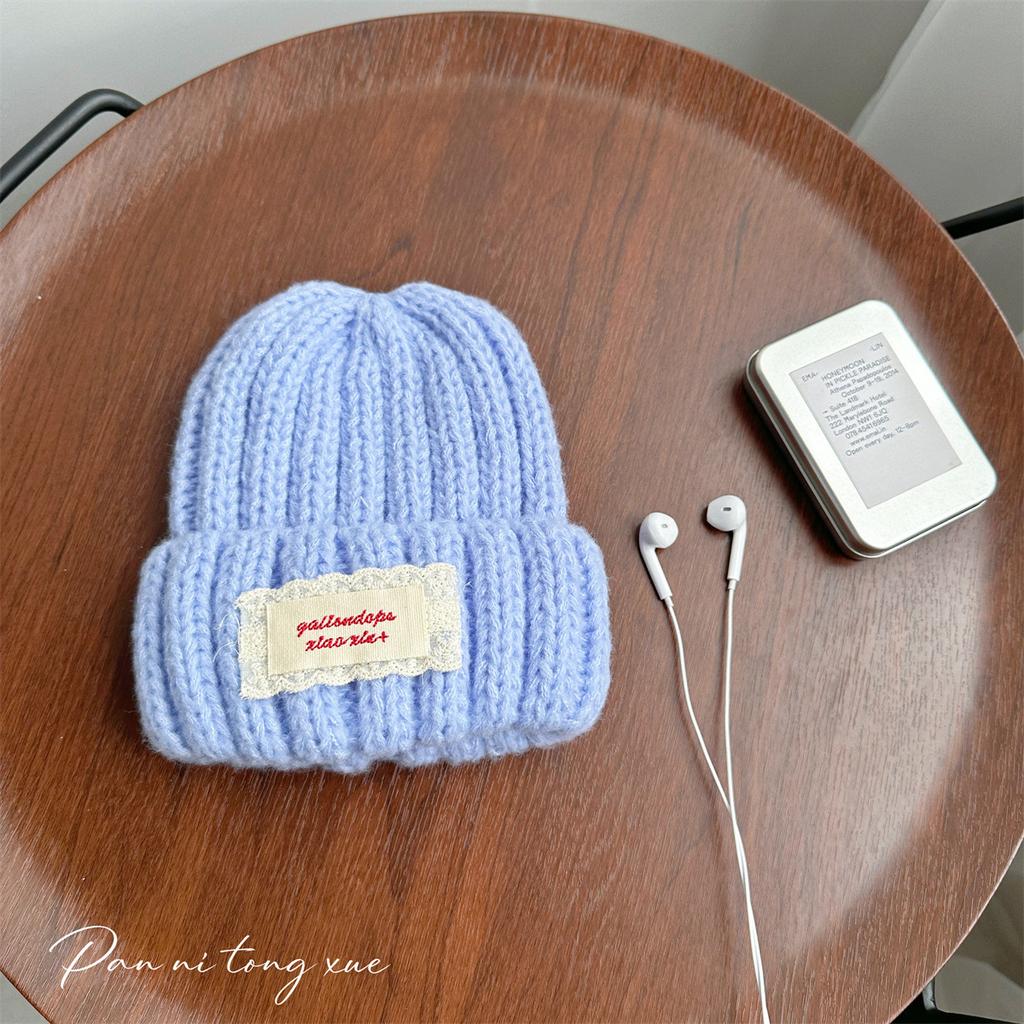 Neue Spitze Etikett Kinder Wollmütze Nuojiji Student Herbst und Winter Neu Warm und Vielseitig Ohrenschutz Strickmütze