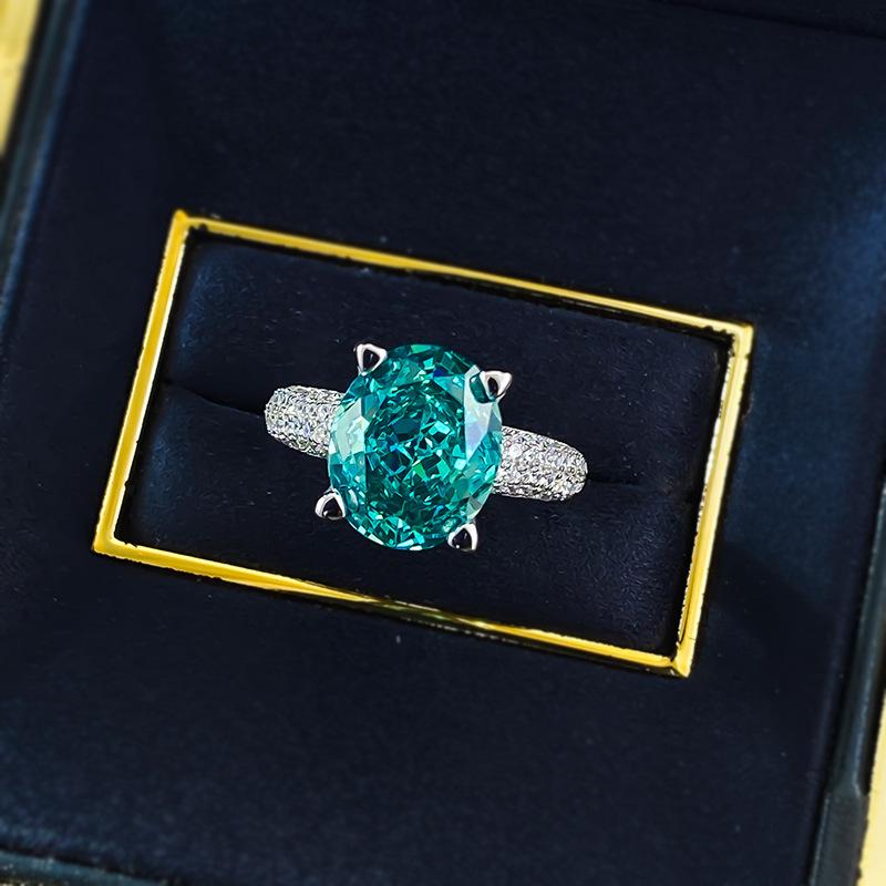 Xiancan Jewelry S925 Silver Oval Paraiba Ice Flower Cut Ring with High Carbon Diamond.