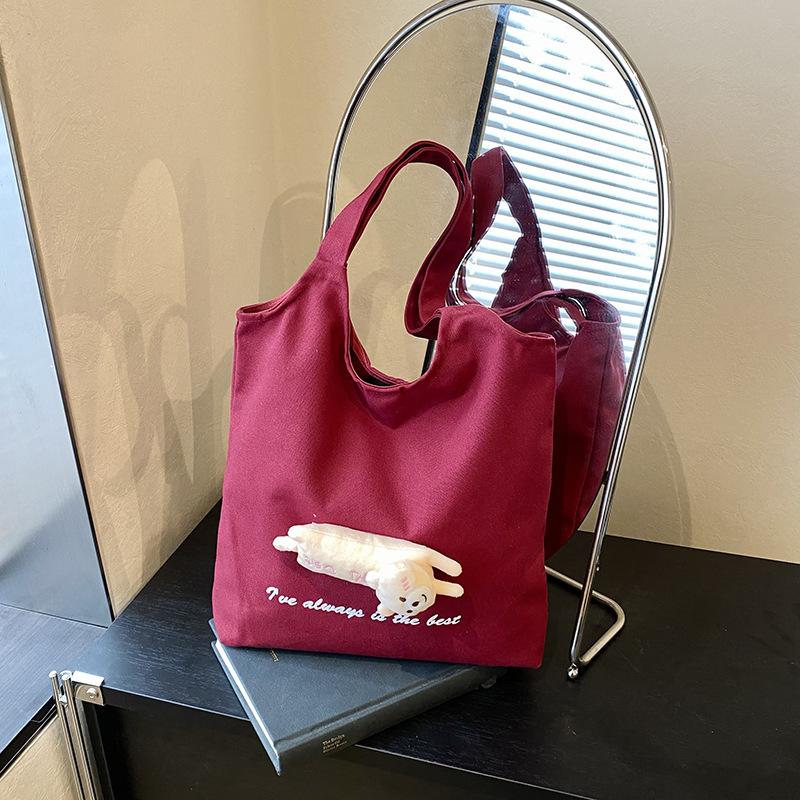 

Cute doll canvas bag bag fashion women lazy wind niche large capacity student commuting shoulder tote bag рожевий червоний колір