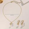 A set of gold stainless steel chains with gold-plated cubic zirconia leaf pendants and pearl necklaces, creative design
