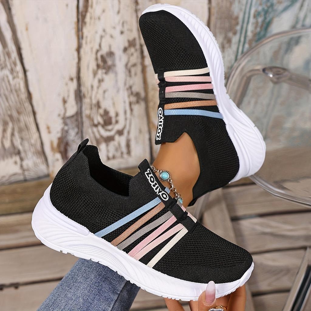 The Lady Wears Slip-On Casual Sports Shoes, Featuring a Breathable Mesh Design with Pastel Stripes, Suitable for Tennis And Comfortable