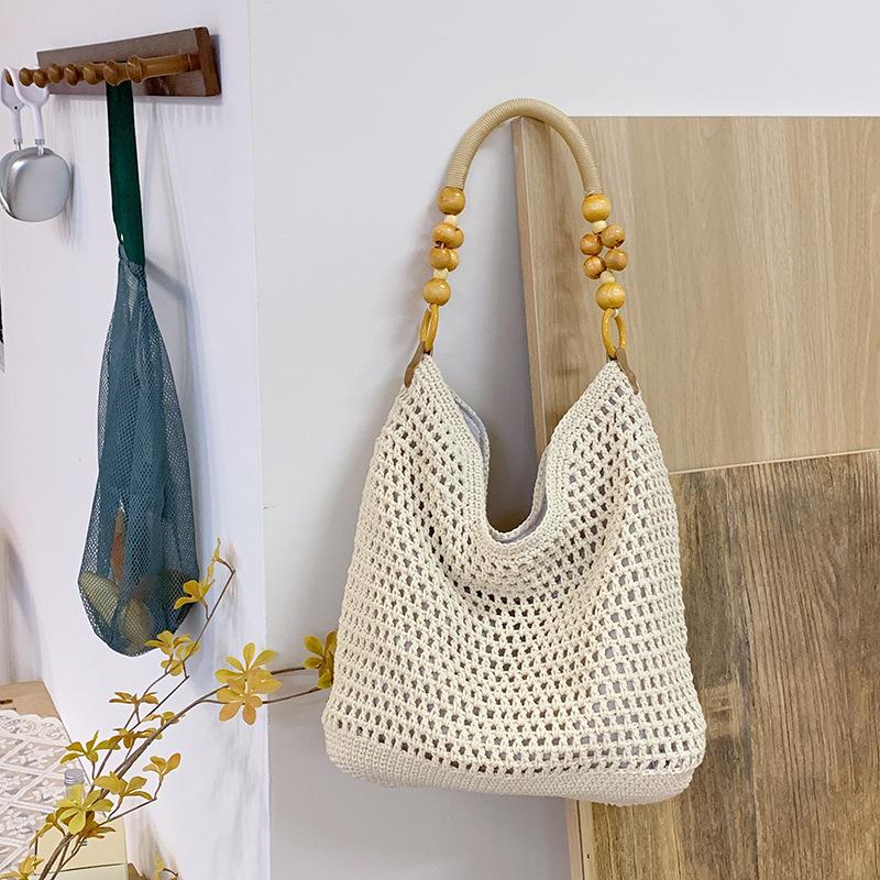 Spring new seaside beach bag women's large-capacity hollow woven shoulder bag versatile portable tote bag