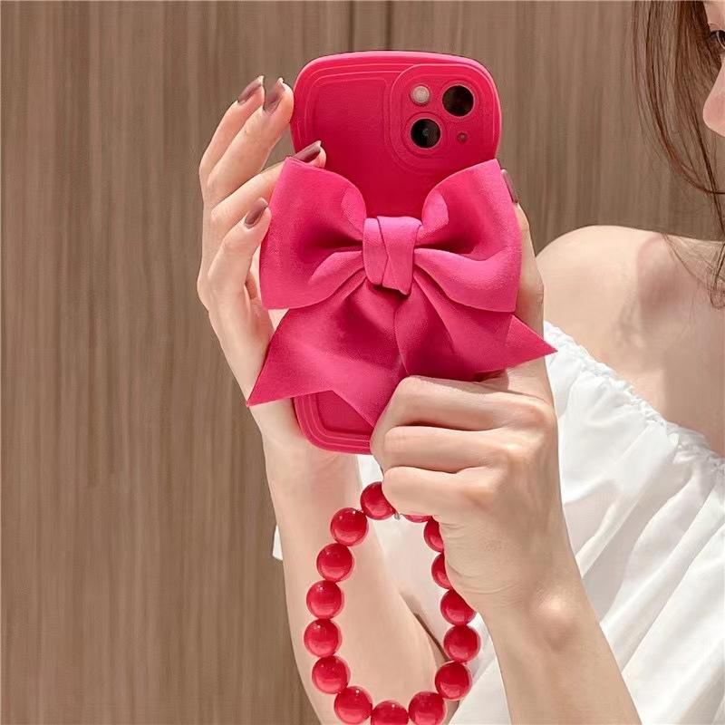 Rose red bow wristband is suitable for Apple 14 mobile phone case, new iPhone13promax women's 12 three-dimensional 11.