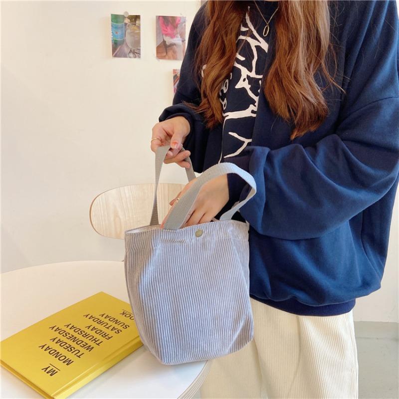 [Spot] Literary and artistic corduroy bag portable casual women's small hand bag retro cloth bag bento bag