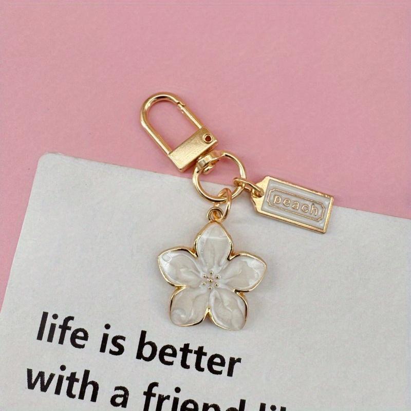 

1pc Metal Sakura Flower Keychain, Lightweight and Graceful Sakura Design with Tag Accessory, Suitable for Bag, Car Keys, Couple & Holiday Gifts белый
