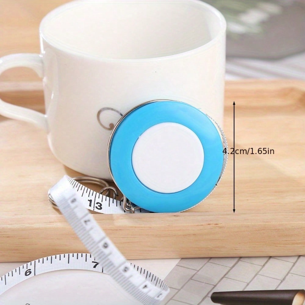 A Stylish Keychain Measuring Tape In Vibrant Colors, Featuring A 1.5-Meter Retractable Design, Perfect for Measuring Clothing Sizes
