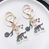Well-Behaved Black Cat Zinc Alloy Keychain: Cute Drip Oil Cartoon Pendant for Backpacks