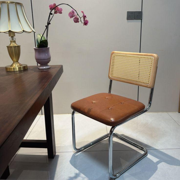 Elegantly crafted armless rattan dining chair in retro pastoral style, perfect for cafes, guesthouses, and vintage settings.