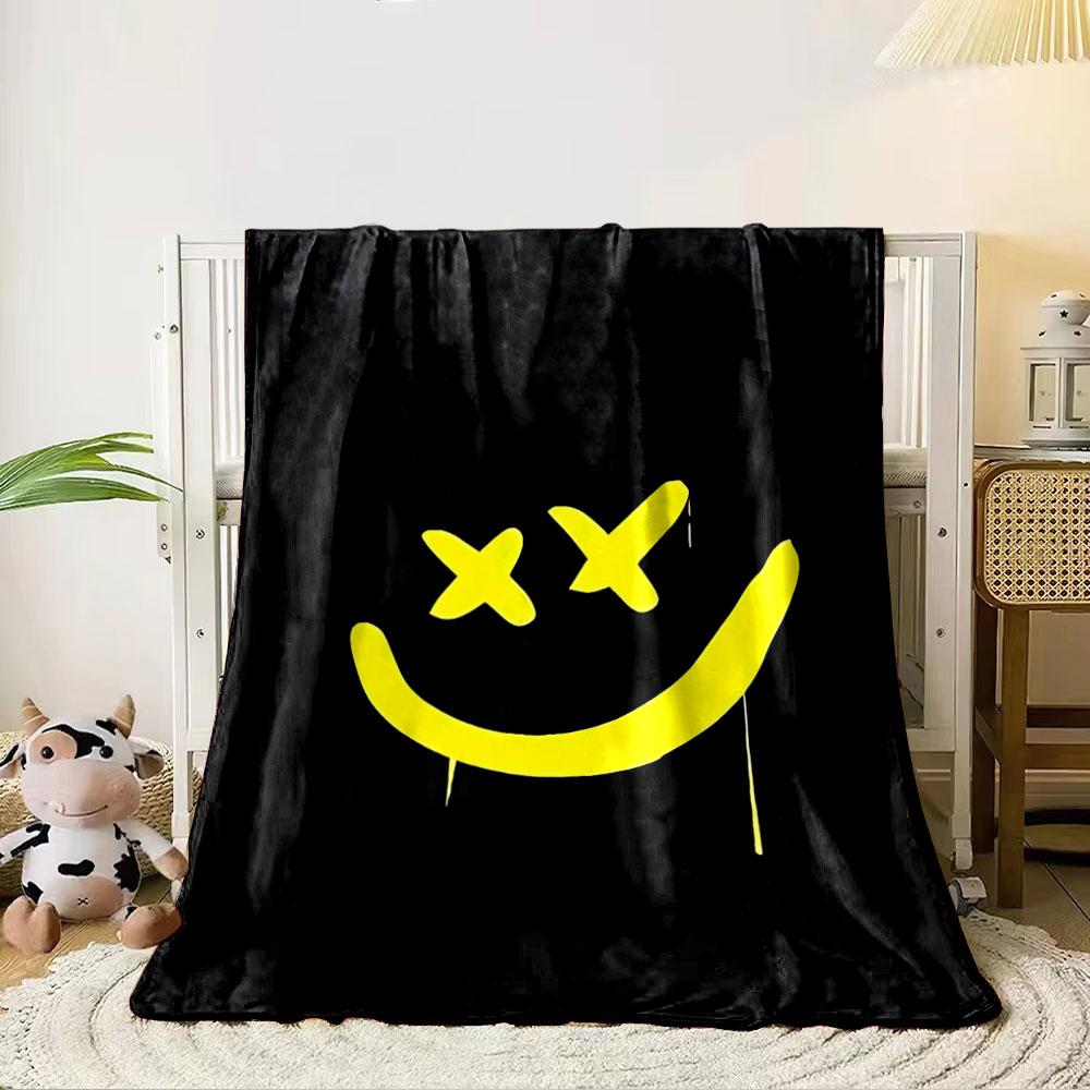 A yellow smiley face with X-shaped eyes on a black background. for all seasons blanket lunch break throw gift 80cm x 120cm