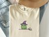 Frog Witch On Broom Embroidered T-Shirt: Cute Halloween Toad, Funny Spooky Season Gift Tee - Whimsical Mage Frog Embroidery