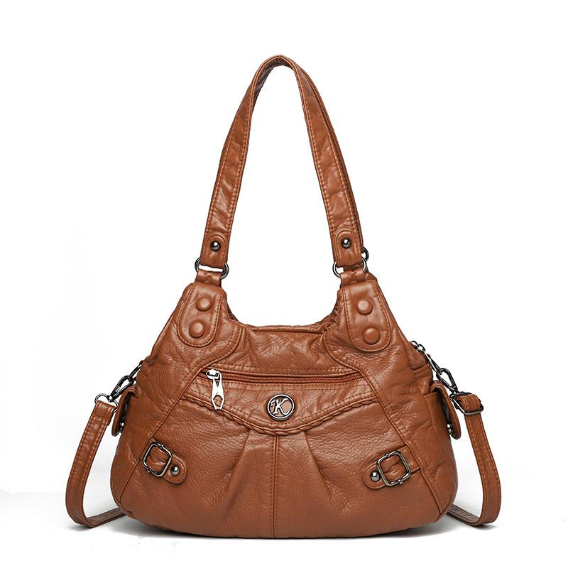 Shoulder leather locomotive bag New large-capacity women's bag Atmospheric commuter bag Woven leather button pleated bag
