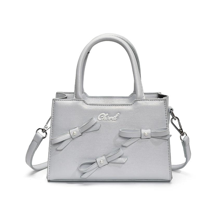 Korean version of bow small square bag women's 2025 summer new simple and fashionable handheld women's bag women's shoulder oblique span bag