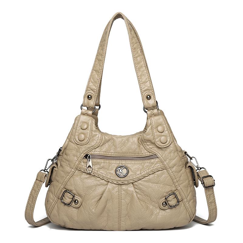 Shoulder leather locomotive bag New large-capacity women's bag Atmospheric commuter bag Woven leather button pleated bag
