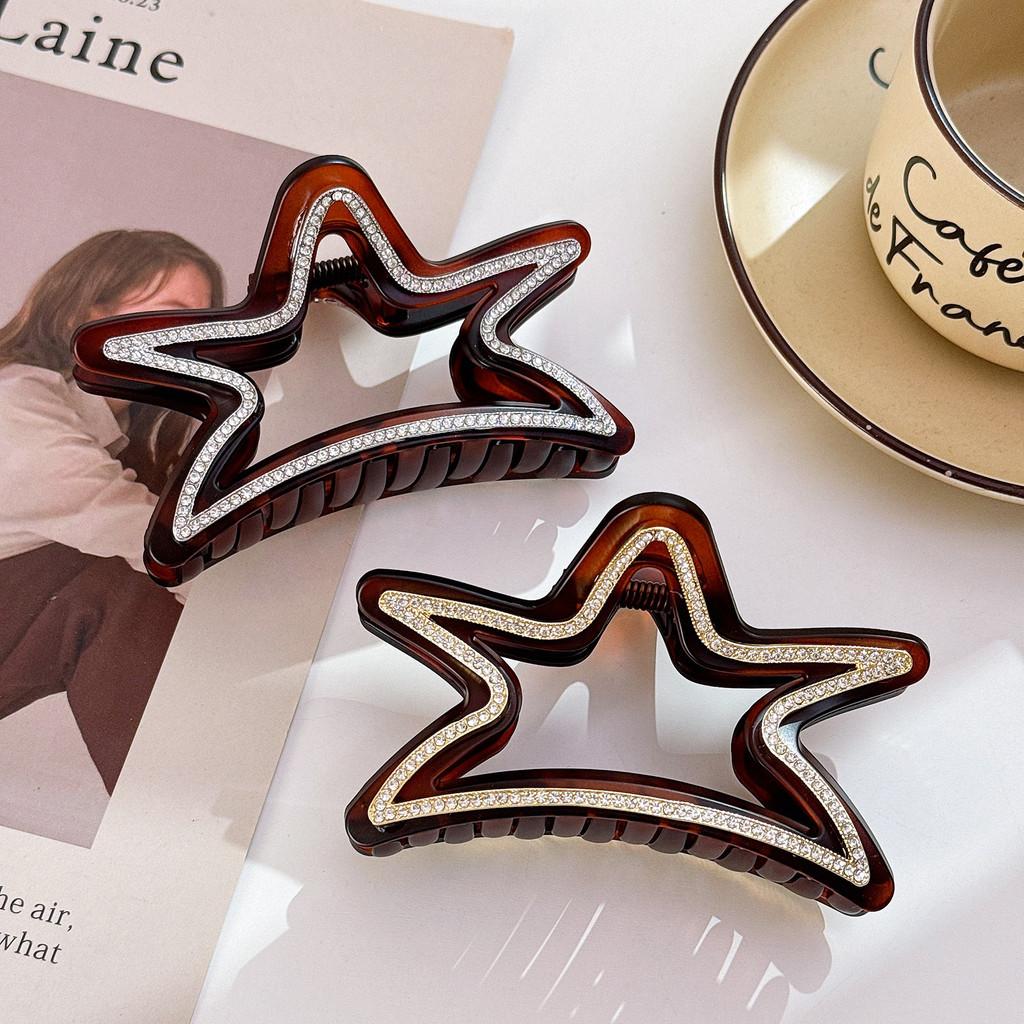 Elegant stjärnformad hårklämma för kvinnor med fantastiska strass i svarta och bruna toner