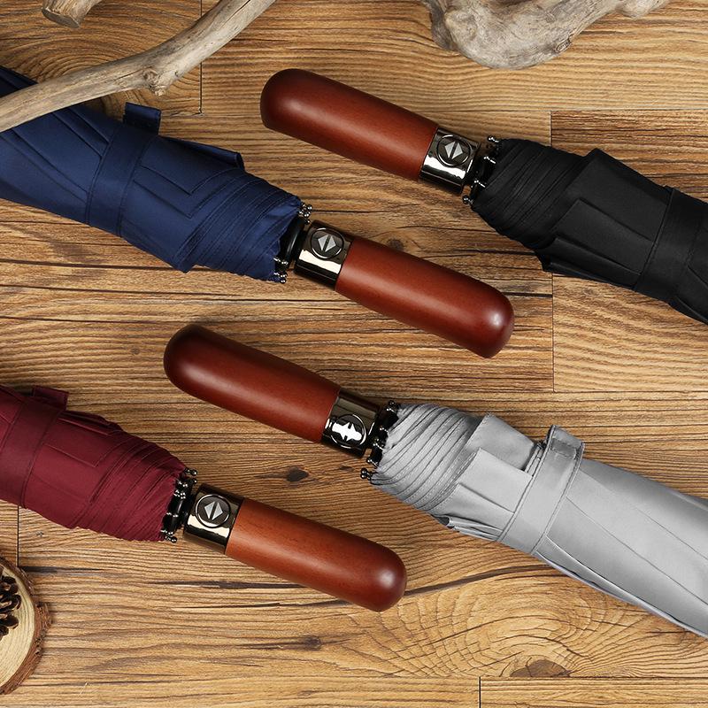 Fully automatic 10-bone wind-resistant solid wood handle lettering three-fold men's umbrella umbrella plus umbrella