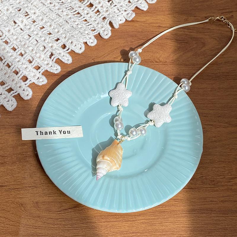 

Жемчужный кулон из вулканической лавы в виде морской звезды, ожерелье, океанский отдых, ветер, цепочка на ключицу, универсальное модное темпераментное украшение для женщин