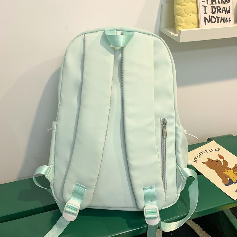 The schoolbag is fresh and sweet, and the solid color is versatile and simple. The schoolbag for junior high school students is light