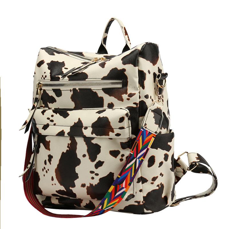 Neuer PU Retro Rucksack mit großer Kapazität für Reisen, Kuhmuster, schlichter britischer Stil, schräg über die Schulter tragbar, für Damen