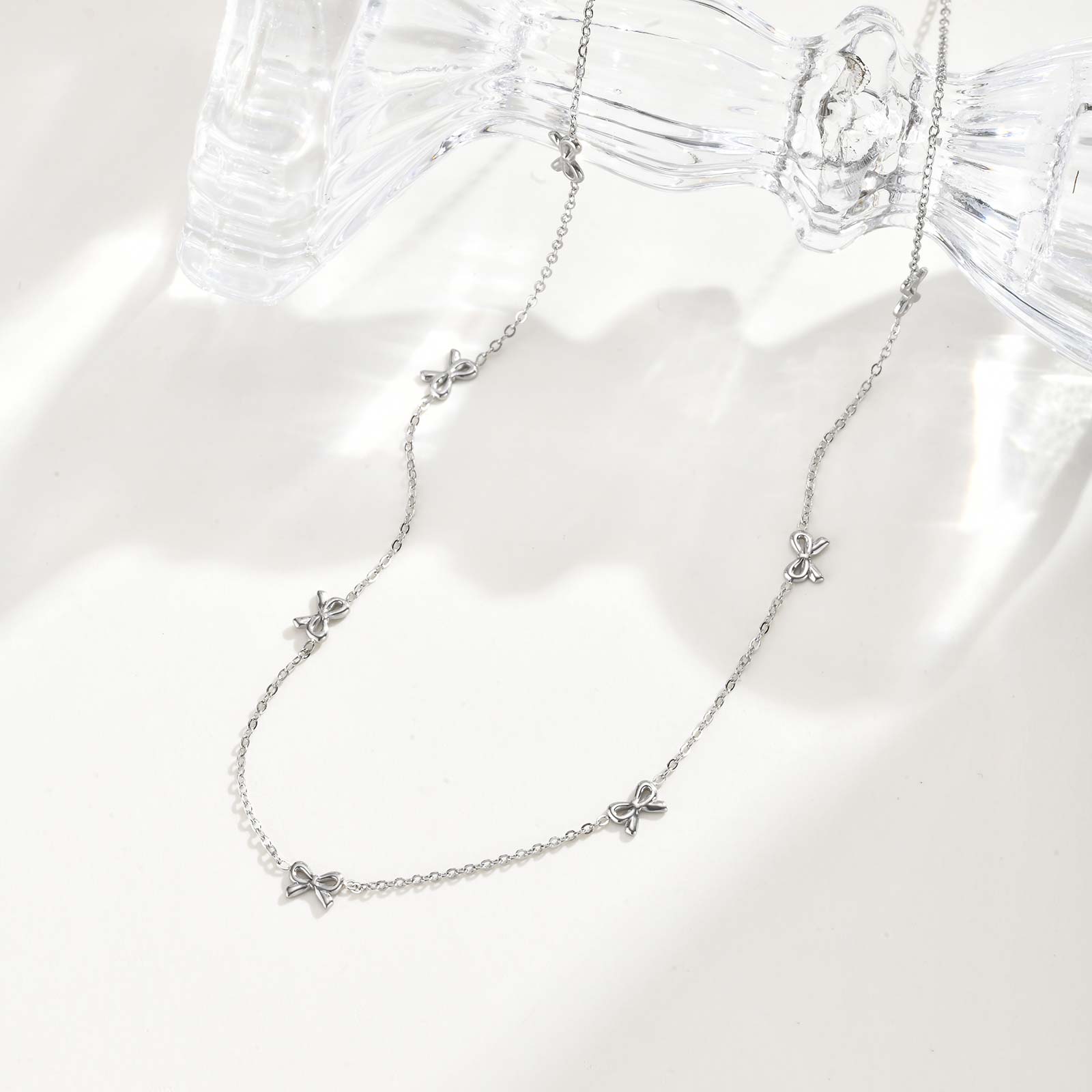 

Minimalist Stainless Steel Necklace with 7 Bowkonts,Waterproof Flat Rolo Chain Bow Necklaces,Classic Jewelry Gift
