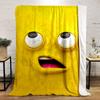 Bright yellow cartoon face with large eyes and an open mouth showing pink. for all seasons blanket lunch break throw gift