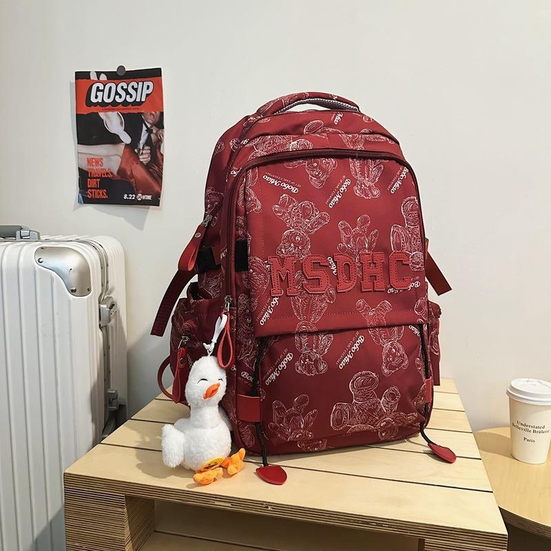 School bag for female junior high school students, simple and versatile printed bear niche design 2025 new college student computer backpack for men