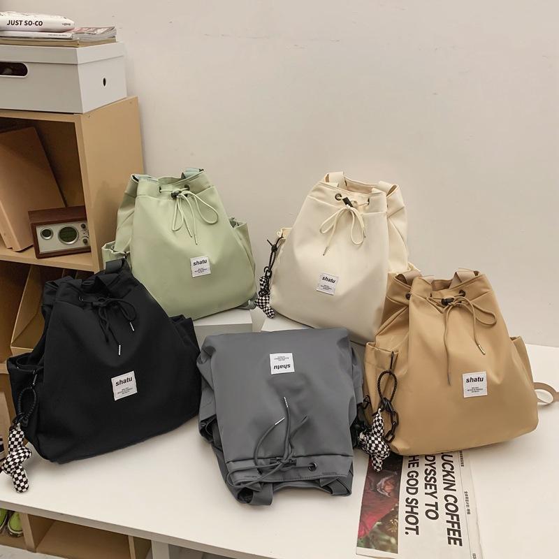 New dual-purpose small backpack, casual niche girlfriend handheld shoulder bag, Japanese and Korean drawstring commuter work backpack