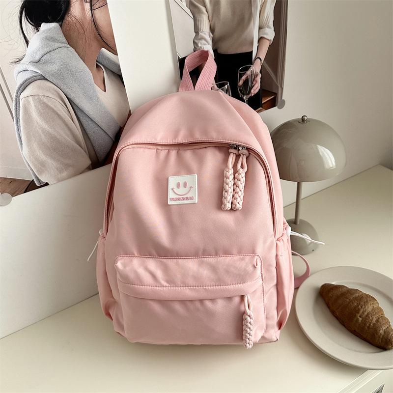 

Solid color simple college student casual backpack high value schoolbag large capacity college style junior high school backpack розовый