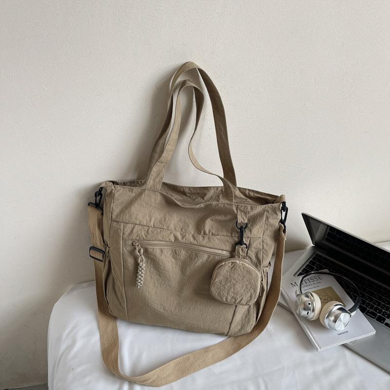

Japanese solid color commuter canvas bag 2025 new student class large capacity shoulder bag niche trend tote bag хаки