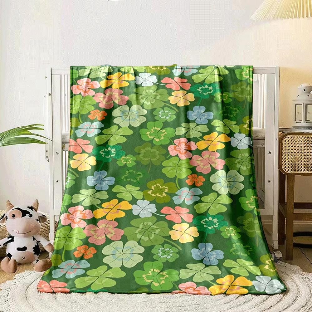 Colorful clovers and flowers scattered on a green background. for all seasons blanket lunch break throw gift