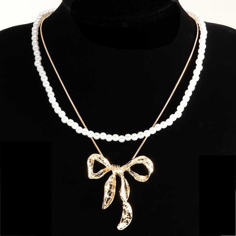 European & American Summer Fashion: Layered Alloy Bow Tie Necklace with Faux Pearl.