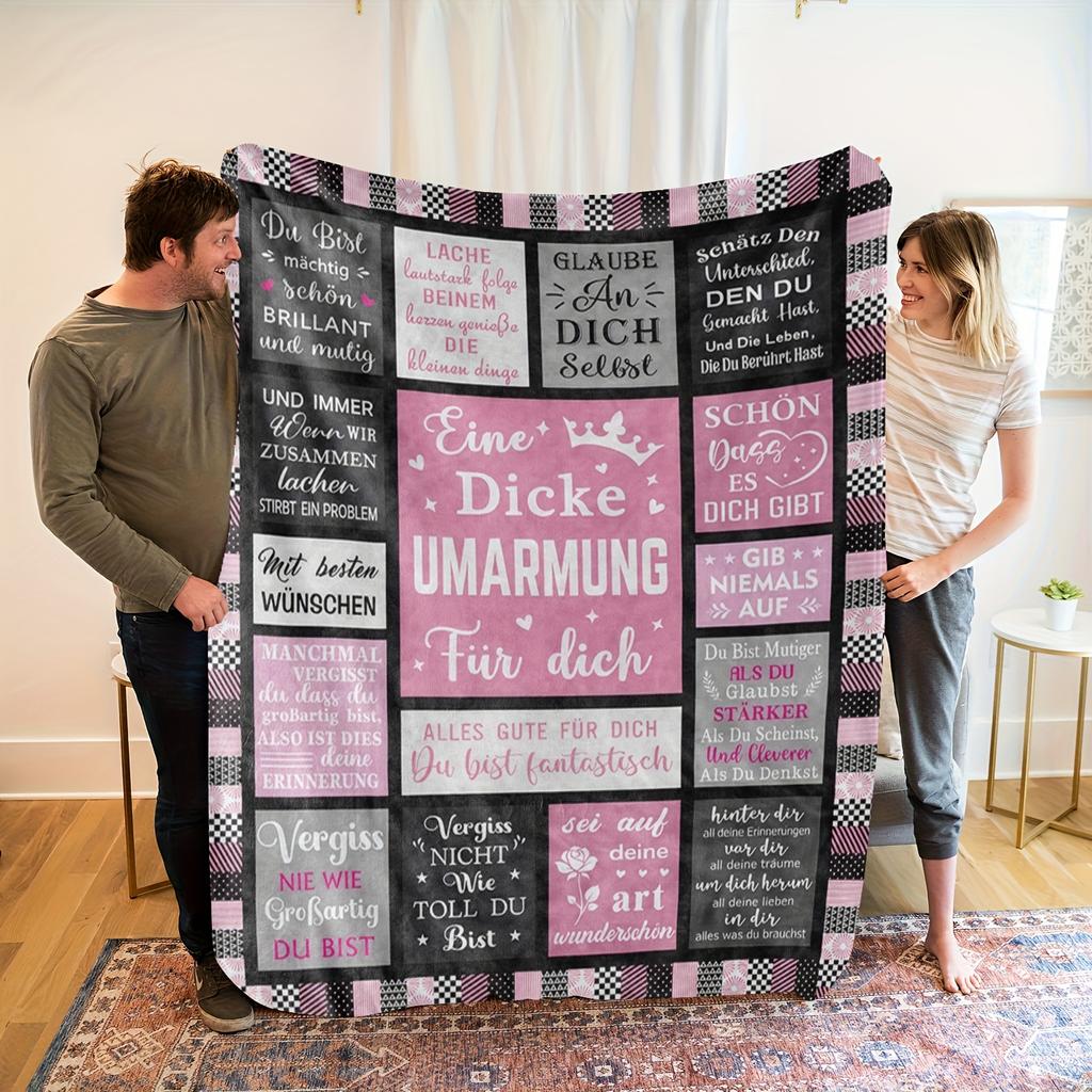 A Cozy German-Themed Graphic Fleece Blanket Made from Soft Fleece Material, Featuring Shades of Black, Gray, And Pink, Suitable for a Trendy