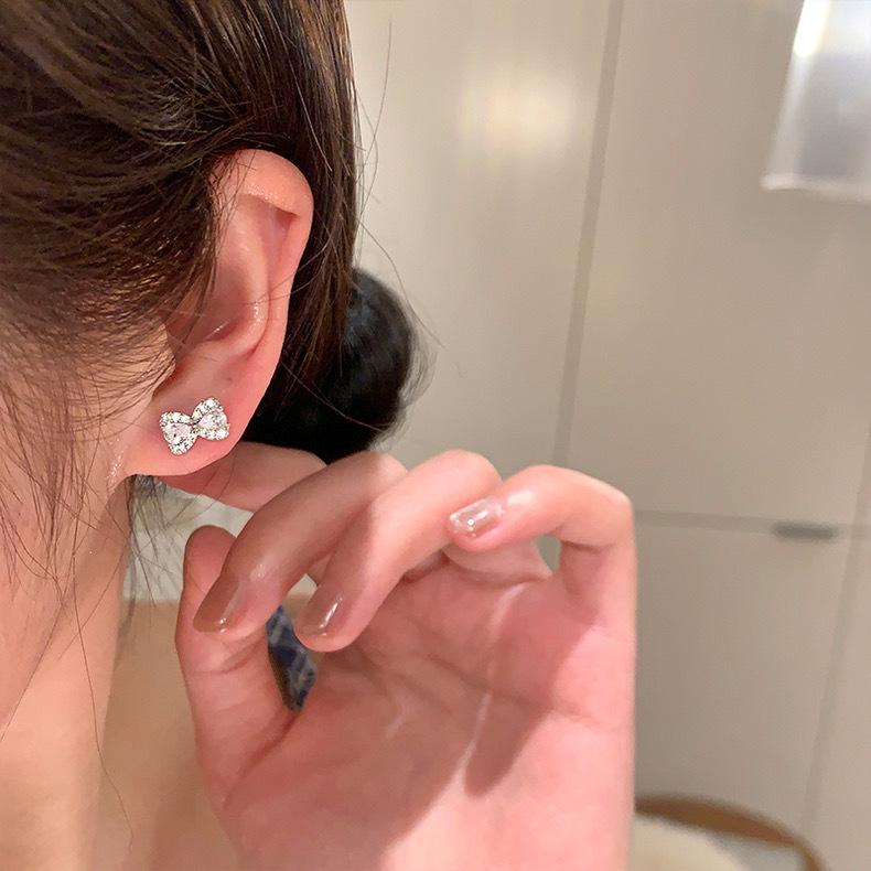

Korean flash zirconium bow titanium steel ear hole earbone nails sleep free temperament exquisite earrings women s stud earrings